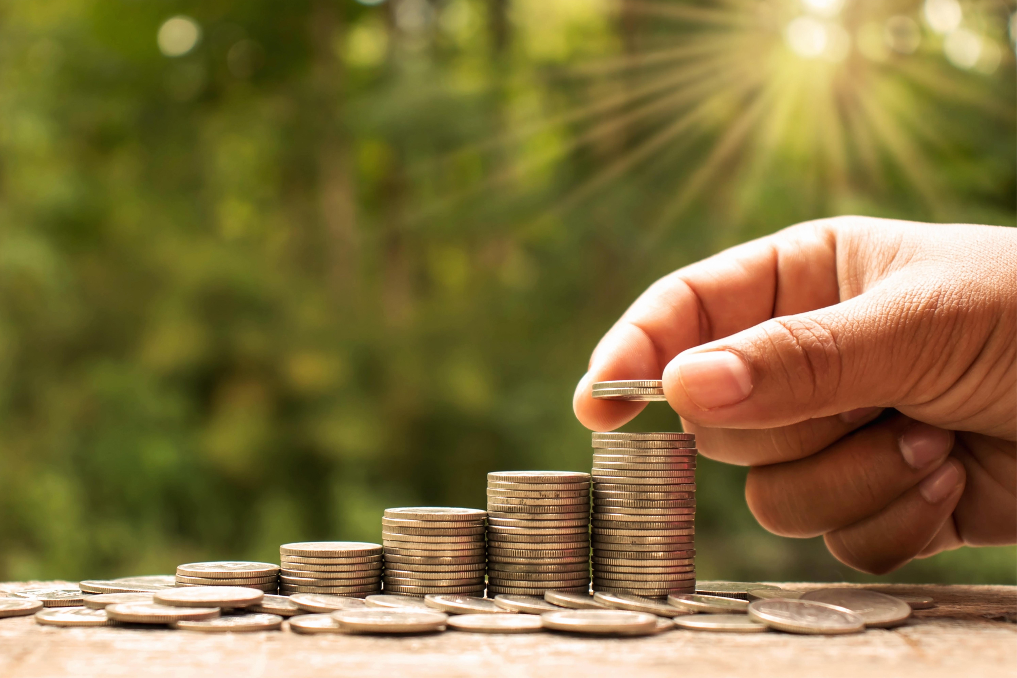 9 month feb 2023 The hands of investors holding coins placed on gold coins at a level different from financial concepts Saving money and investing , CD , cd rates